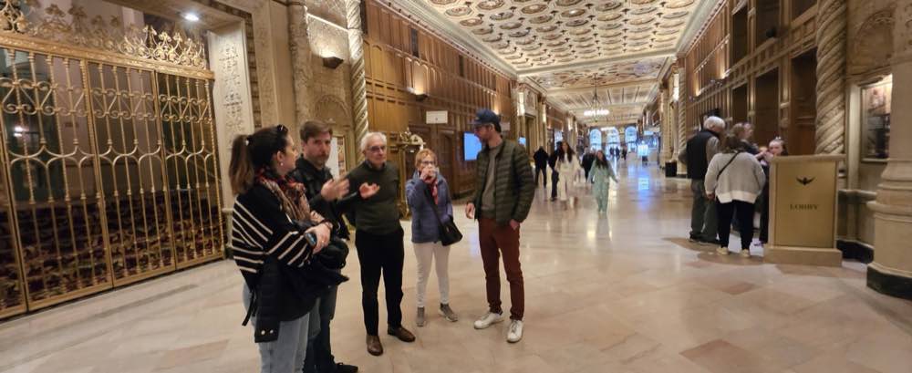 A guide and a small group of guests in the Biltmore's ornate Galleria.